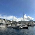 Fishing boats and historic waterfront along Ålesund’s harbor, Norway — coastal architecture and fjord scenery.